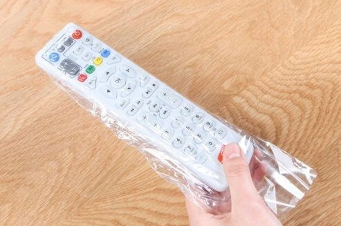 covering the remote control with a plastic wrapper